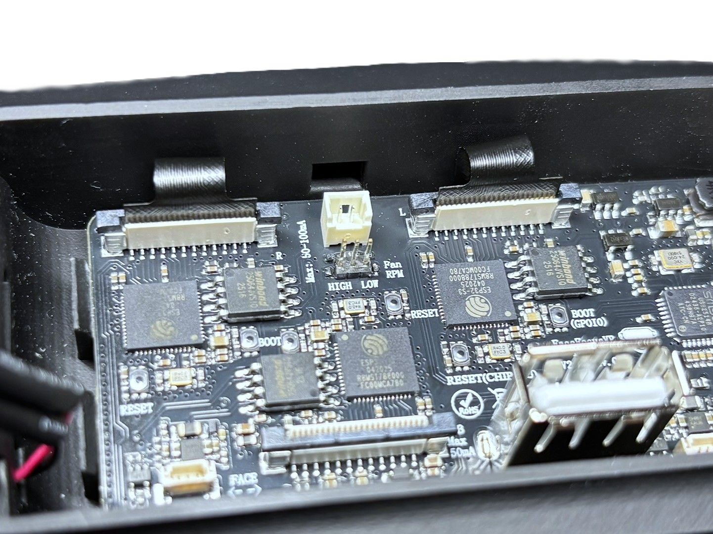 Black tabs lifted to open the ribbon cable connector